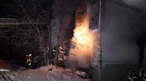 Firemen attending house fire with flames and snow Stock Footage 39765206