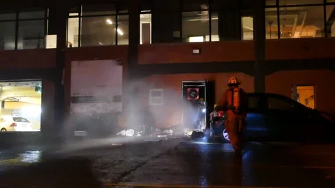 Firemen avoiding water jet Stock Footage 99842404