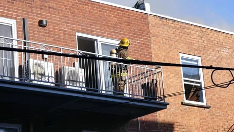 Firemen on balcony Stock Footage 101995712