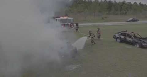 Firemen battle car fire Stock Footage 220574405