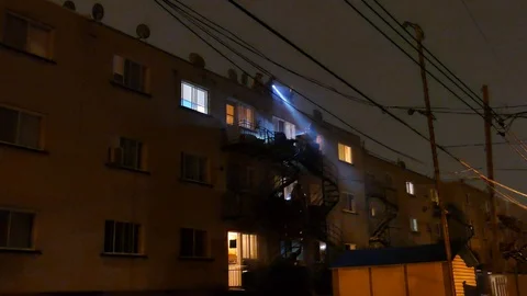 Firemen behing apartment building Stock Footage 116711551