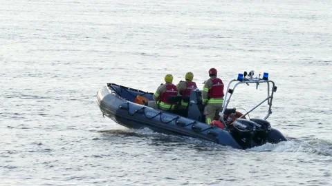 Firemen on boat saying bye bye Stock Footage 139658807