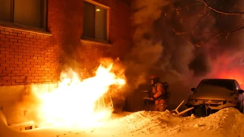 Firemen breaking basement window and letting smoke out Stock Footage 105918733
