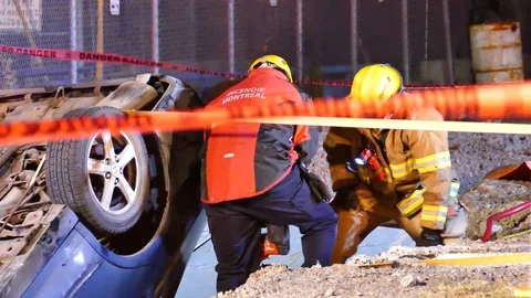Firemen building ramp to get victim out of car accident Stock Footage 100641460