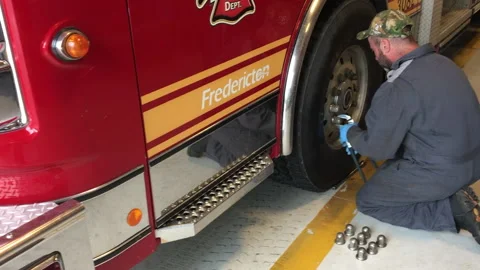 Firemen checking the trucks lug nuts Stock Footage 208078893