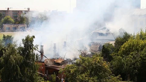 Firemen continue to extinguish a strongly smoking object Stock-Footage 79503487