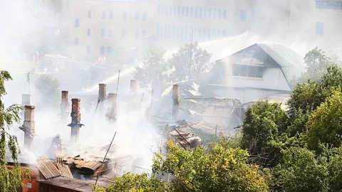 Firemen continue to extinguish a strongly smoking object Stock Footage 80258505