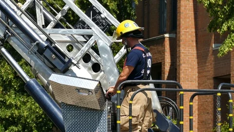 Firemen controlling ladder at daylight Stock Footage 116078032