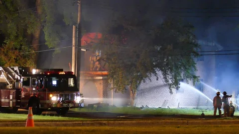 Firemen in defensive mode at abandonned house fire Stock Footage 114765959