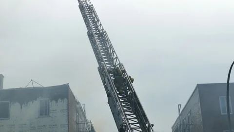 Firemen descending ladder Stock Footage 114769979