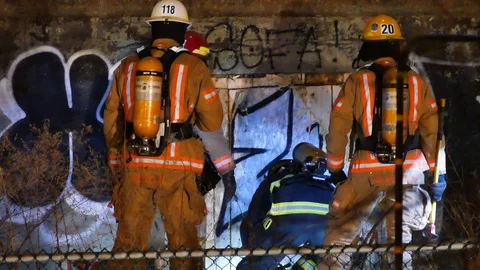Firemen destroying the wall of a church Stock Footage 105342054