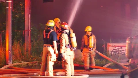 Firemen directing water jet Stock Footage 115979782