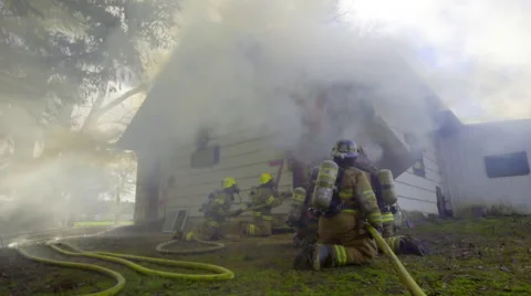 Firemen duck down to avoid big flames Stock Footage 60751878