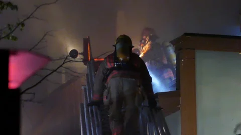 Firemen escalading fire Stock Footage 116076602