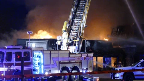 Firemen exposed to danger created by irresponsible arsonist in Laval Stock Footage 129987750