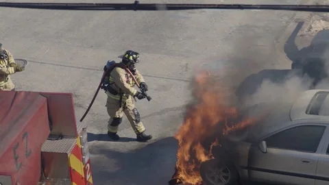 Firemen extinguish car on fire Stock Footage 124664613