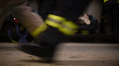Firemen Feet rush through frame (slide left) Stock Footage