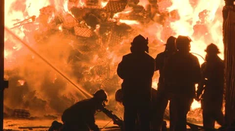 Firemen fight a huge blaze at an Industrial fire Stock Footage
