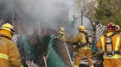 Firemen fighting fire with axe and chainsaw Stock Footage 40313612