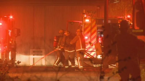 Firemen first on scene at a shed fire Stock Footage 862583
