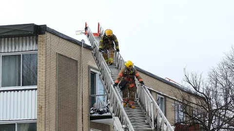 Firemen getting off ladder Stock Footage 125452476