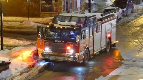 Firemen getting out of firetruck during winter Stock Footage 139663789