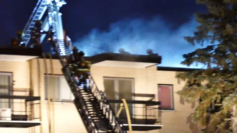 Firemen getting the roof during working fire Stock Footage 114648413