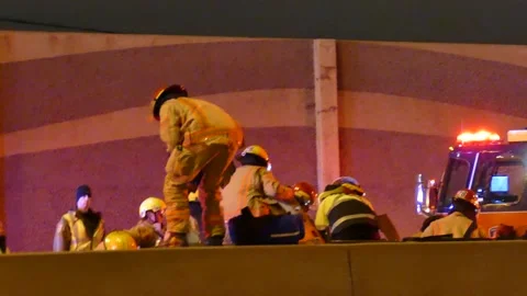 Firemen getting sheet to hide victim from the camera Stock Footage 133275135