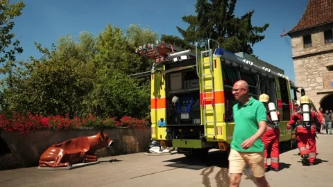 Firemen in helmets running near fire truck. Schaffhausen,Switzerland,08.08.2022 Stock Footage 204014708