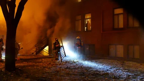 Firemen helping woman stuck inside his apartment in fire Stock Footage 100641787