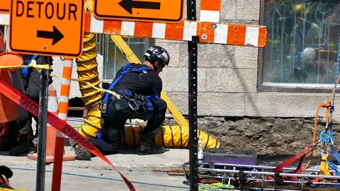 Firemen helping worker falled in a hole Stock Footage 115936329
