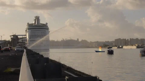 Firemen hose down a boat on fire in harbor / bay from firetruck Stock Footage 32712696