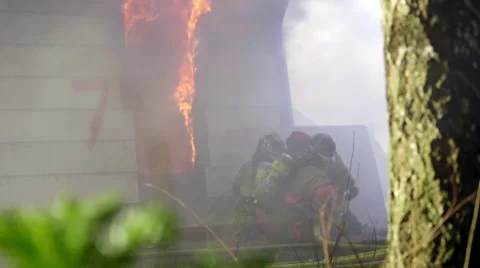 Firemen hose down huge flames Stock Footage 60761859