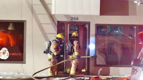 Firemen with hoses at structure fire Stock Footage 139663806