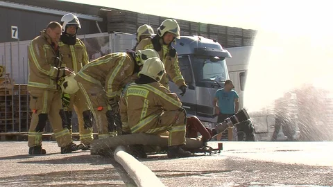 Firemen installing a hose during a firedrill Stock Footage 128314406