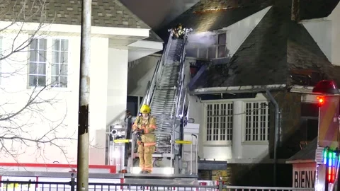 Firemen with ladder at structure fire Video stock 139657489