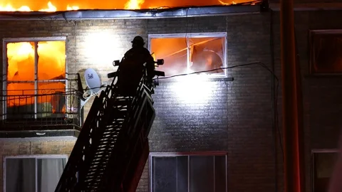 Firemen on ladder trying to exthinguish flames Stock Footage 105302082