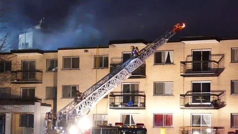Firemen on ladder working on structure fire Stock Footage 114647970