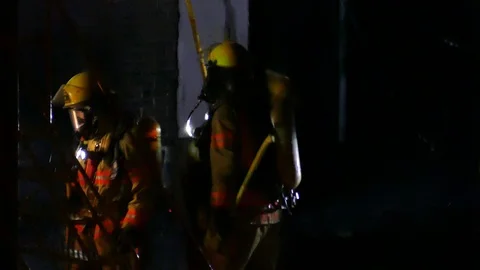 Firemen making roof falling Stock Footage 114757596