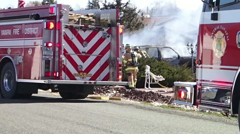 Firemen mop up a vehicle fire Stock Footage 51332795