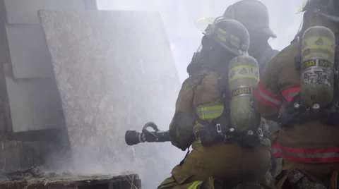 Firemen prepare to use their water hose Stock Footage 60761554