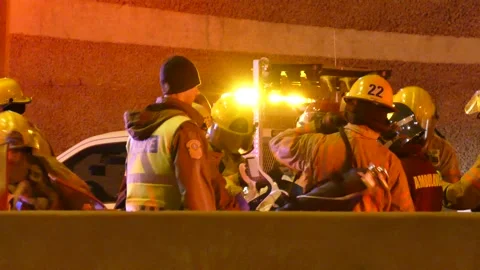 Firemen putting collard around the neck of the victim Stock Footage 133275113
