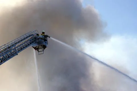Firemen putting out a fire Stock Photos