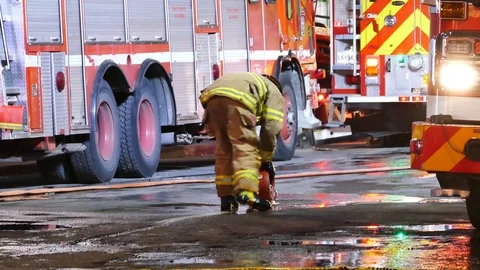 Firemen rolling firefighters pipe Stock Footage 99874687