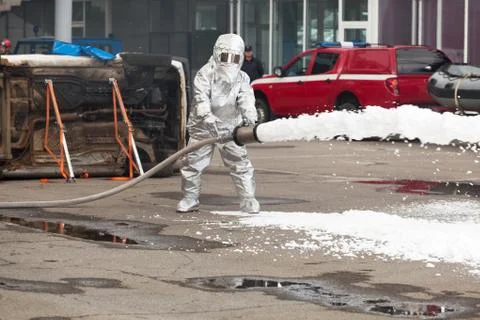 Firemen spray firefighting foam Stock Photos