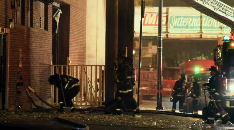 Firemen sweeping up after explosion 스톡 동영상 644888