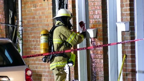 Firemen taping crime scene Stock Footage 116710320