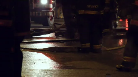 Firemen Tilt Up to Guys Talking Stock Footage 644896