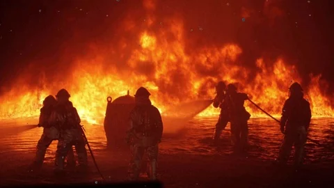 Firemen training exercises hot flying embers cinemagraph Stock Footage 97740098