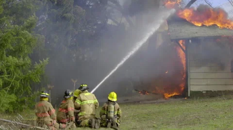 Firemen try to contain huge flames Stock Footage 61180306